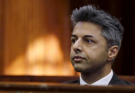 Honeymoon murder accused Shrien Dewani sits in the dock before the start of his trial in Cape Town