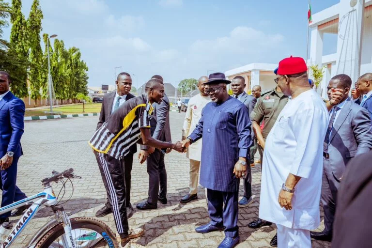 Gov. Sheriff Oborevwori of Delta (R) on a handshake with Mr Samuel Okoro, a cyclist, who rode from Damaturu, Yobe to Asaba, Delta State in 10 day in honour of Gov. Oborevwori on Wednesday in Asaba