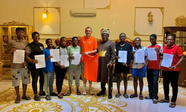 OPM-General-Overseer-Apostle-Chibuzor-Chinyere-flanked-by-an-official-of-Lithuanian-Football-Club-FK-Dembava-during-the-contract-signing-of-23-Nigerian-footballers-in-Port-Harcourt
